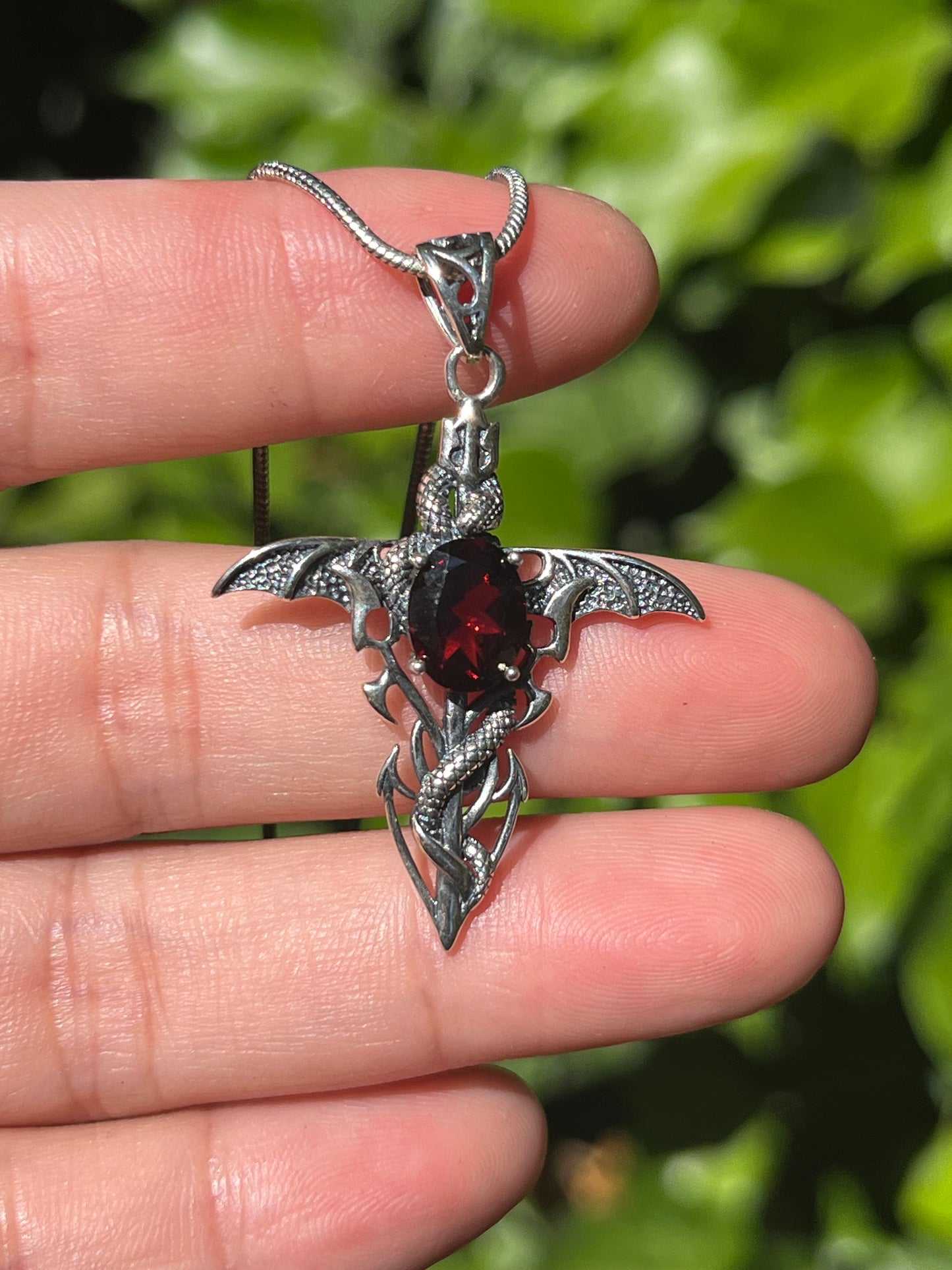 Sterling silver faceted garnet snake cross