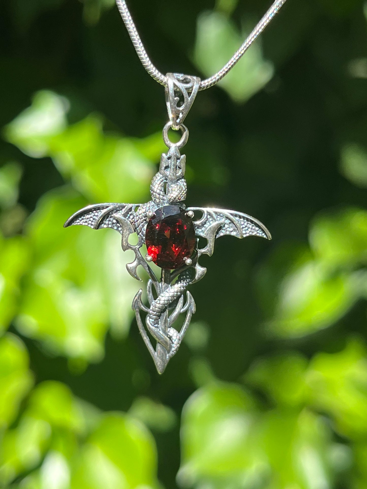 Sterling silver faceted garnet snake cross