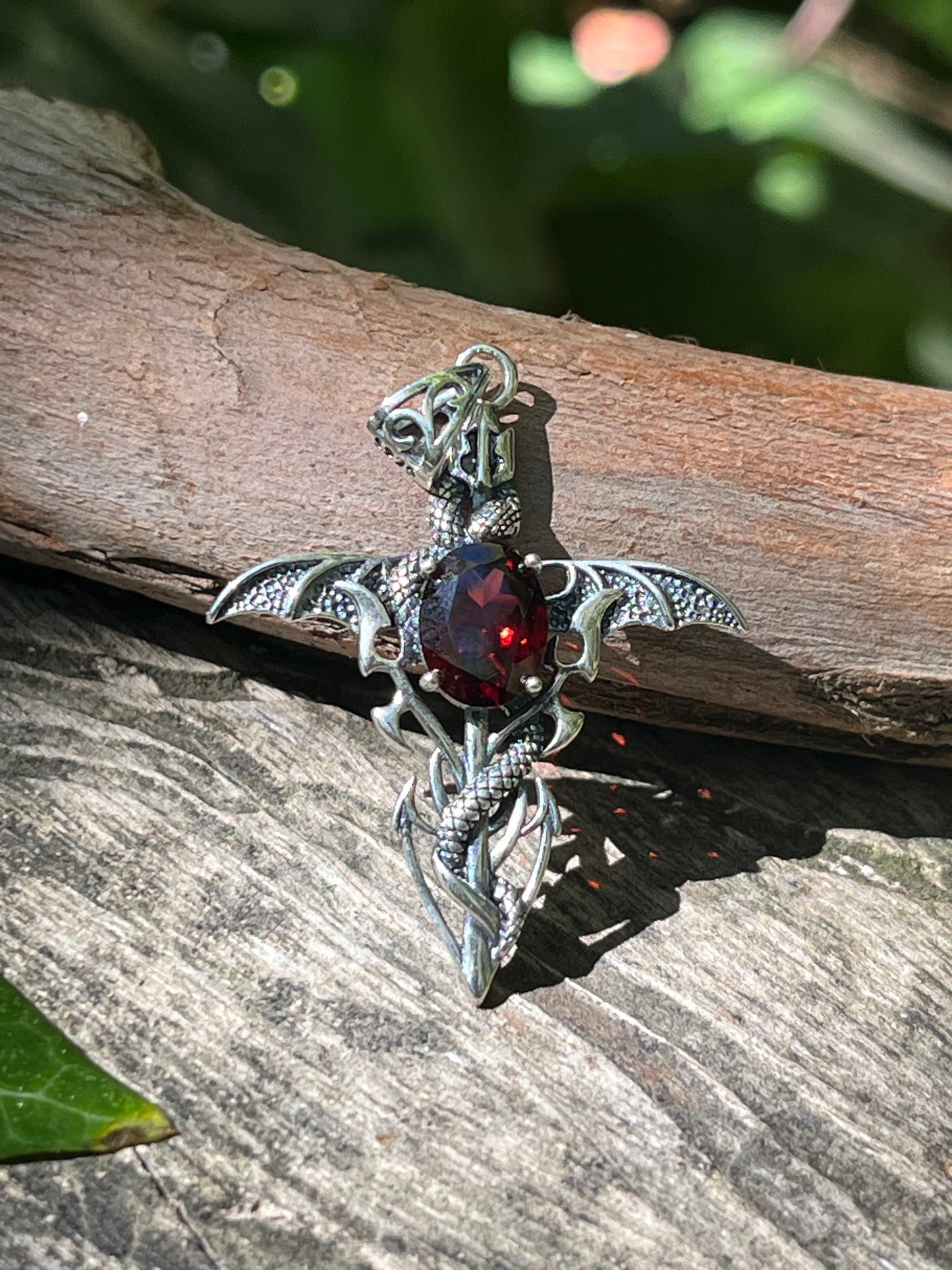 Sterling silver faceted garnet snake cross