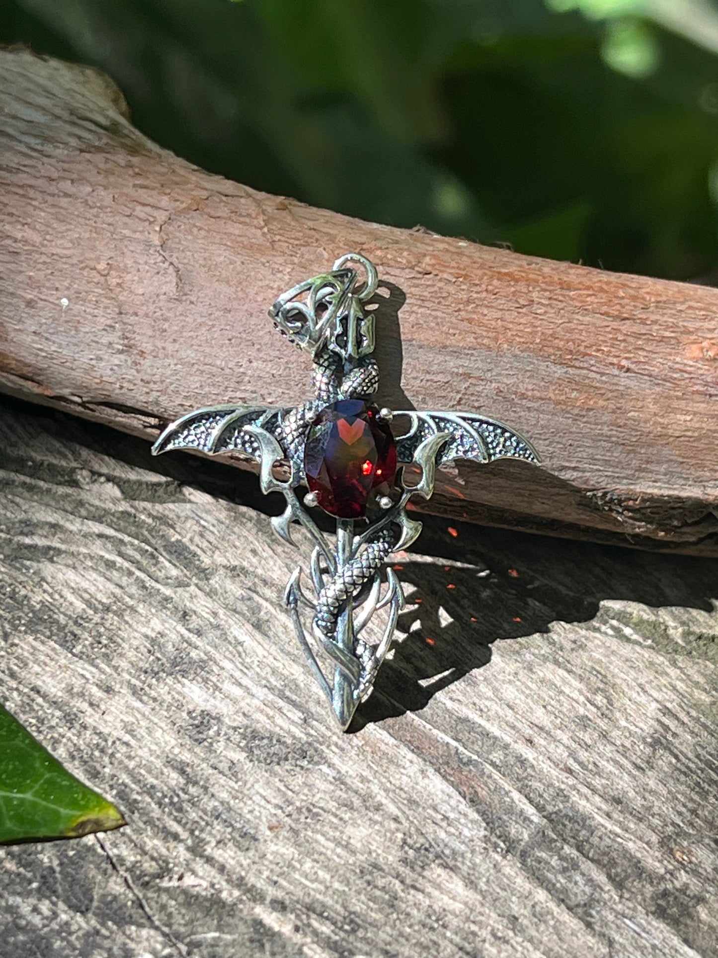 Sterling silver faceted garnet snake cross